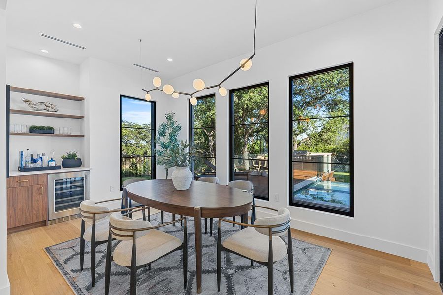 Dining offset but still feels part of the core of the house. Overlooks gorgeous pool & backyard. Dining offset but still feels part of the core of the house. Overlooks gorgeous pool & backyard.