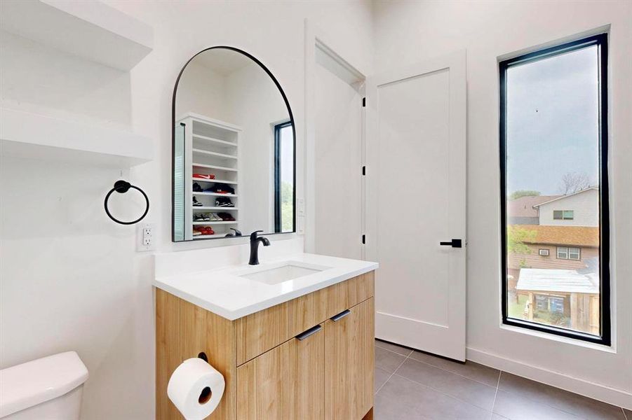 Bathroom with vanity, tile patterned flooring, and a closet Bathroom with vanity, tile patterned flooring, and a closet