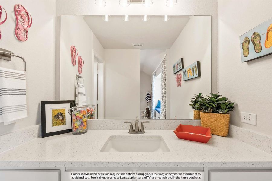 Bathroom vanity with quartz countertop, undermount sink, large mirror, and gray cabinets