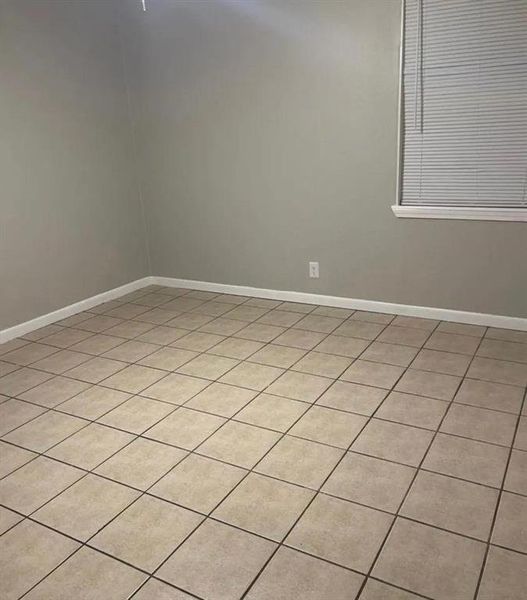 Empty room with light tile patterned floors