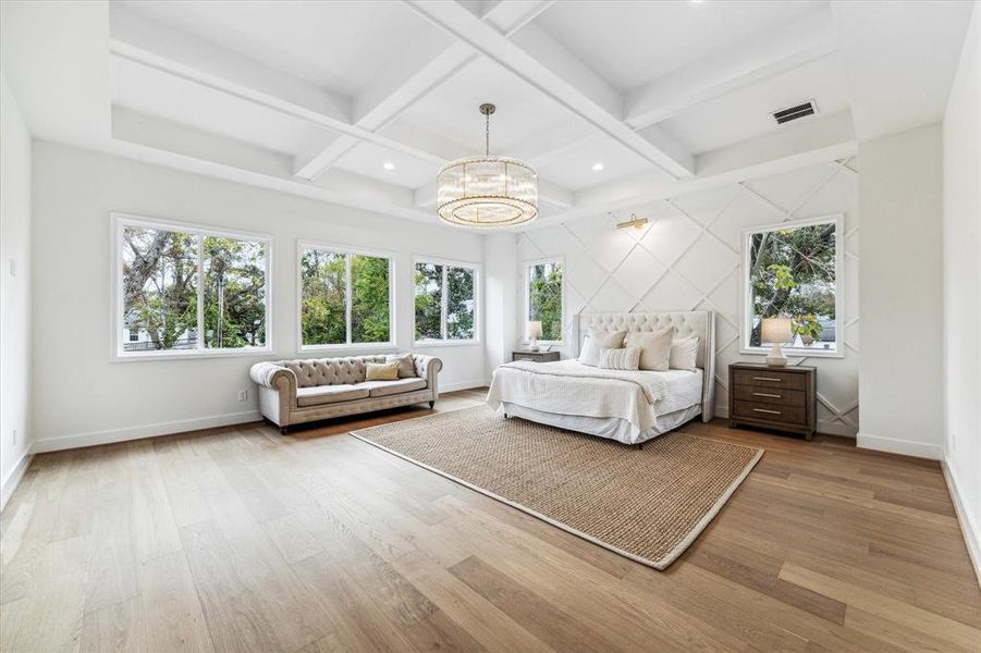 Enormous primary suite with boxtray ceiling - numerous windows give you a view from the treetops