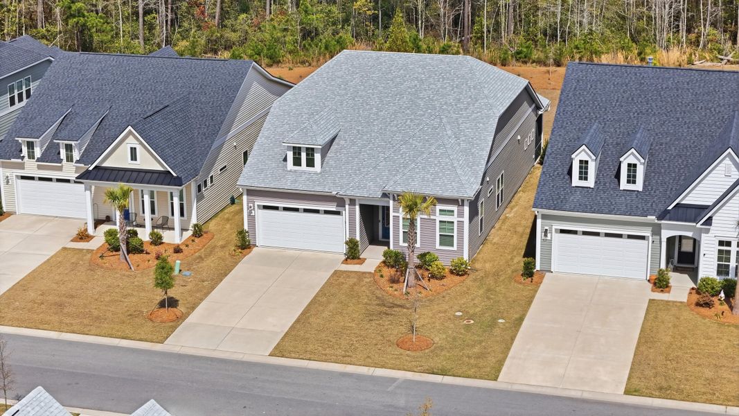 Front exterior of a new home in Summerwind Crossing at Lakes of Cane Bay, Summerville, SC, highlighting curb appeal (Image 24).