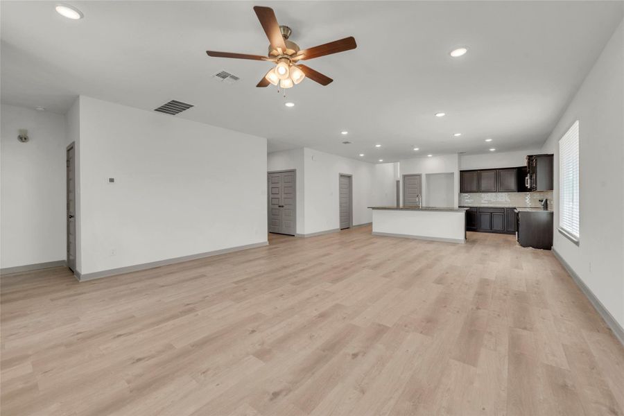 Unfurnished living room featuring recessed lighting, light wood-style flooring, and a ceiling fan