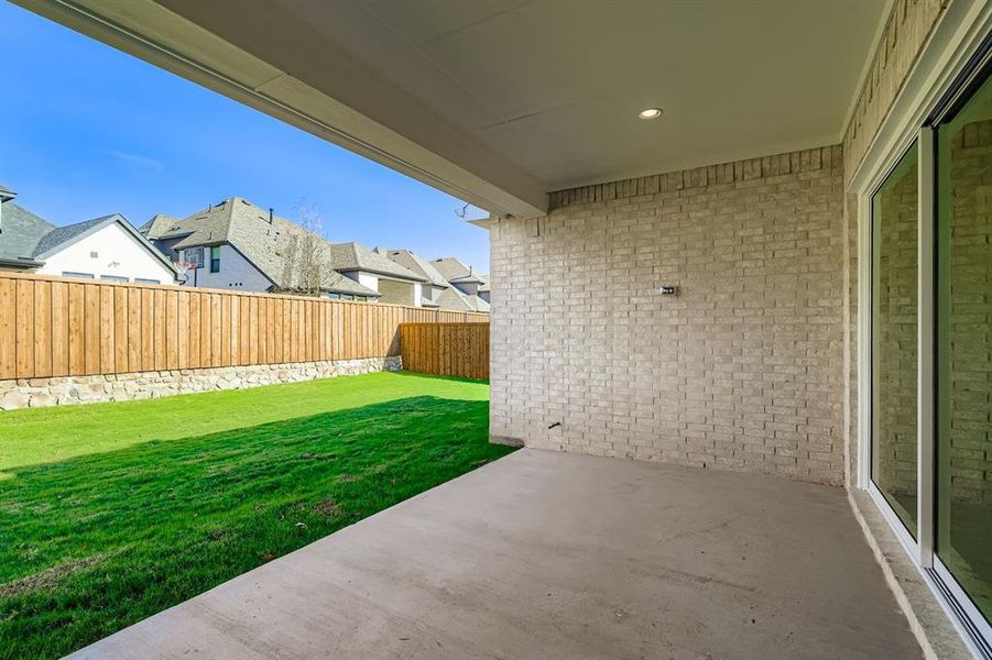Fenced backyard featuring a patio and a residential view Fenced backyard featuring a patio and a residential view