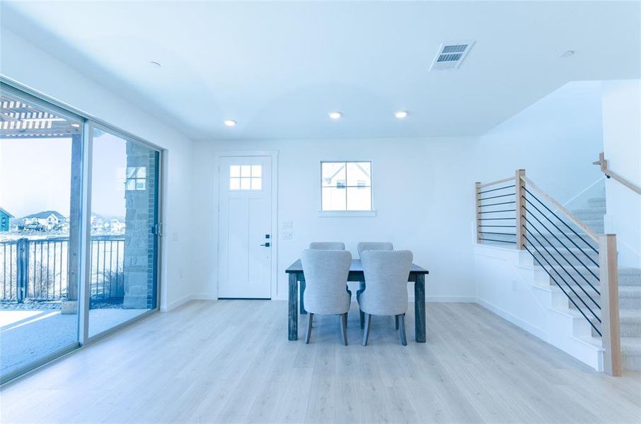 Dining space featuring light wood finished floors and recessed lighting