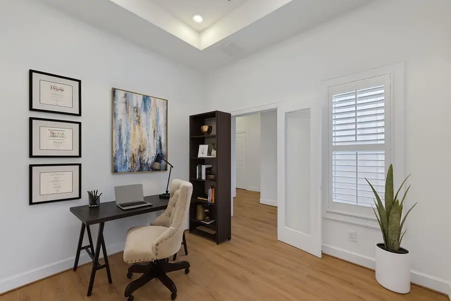 This staged study boasts ample natural light, elegant wood flooring, and a sophisticated design, perfect for productive work or peaceful reflection. (wood blinds are only in photo) This staged study boasts ample natural light, elegant wood flooring, and a sophisticated design, perfect for productive work or peaceful reflection. (wood blinds are only in photo)