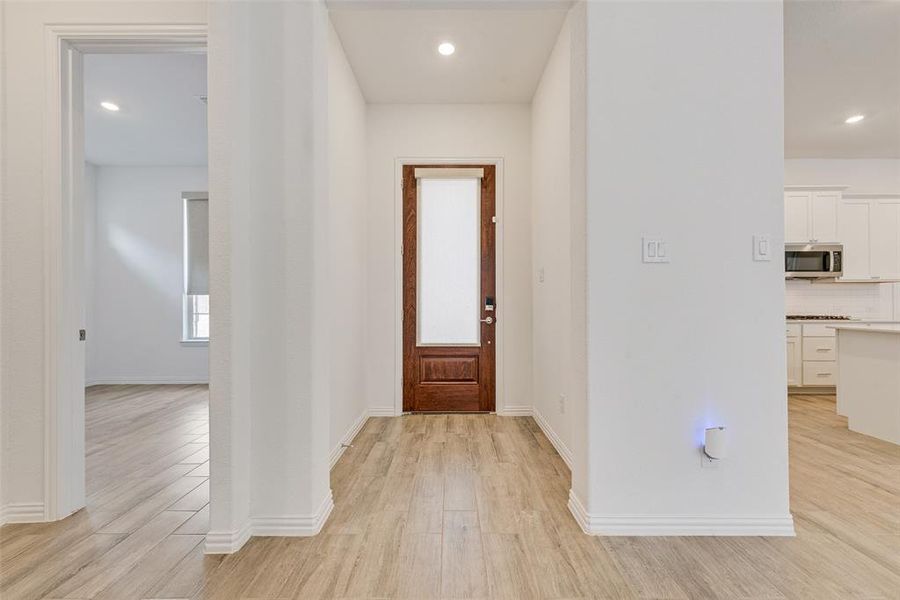 Foyer entrance with light wood-style flooring and recessed lighting Foyer entrance with light wood-style flooring and recessed lighting