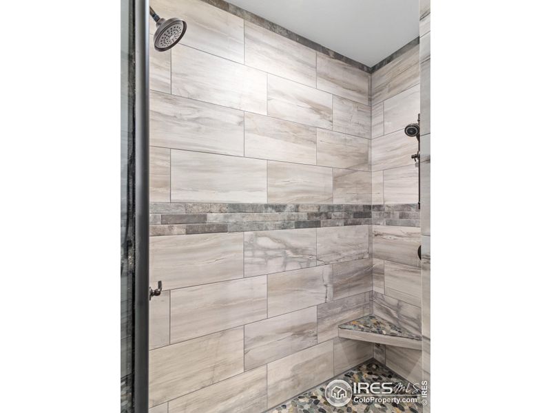 Twin shower heads and custom tile in primary bath Twin shower heads and custom tile in primary bath