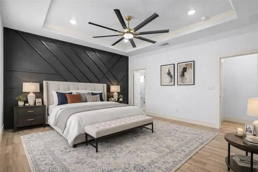 Bedroom with an accent wall, light wood-style floors, a decorative wall, recessed lighting, and ceiling fan