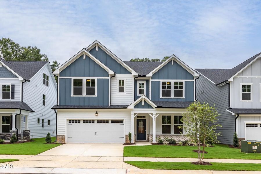 Front exterior of a new home in Sage on North Main, Wake Forest, NC, highlighting curb appeal (Image 1). Front exterior of a new home in Sage on North Main, Wake Forest, NC, highlighting curb appeal (Image 1).
