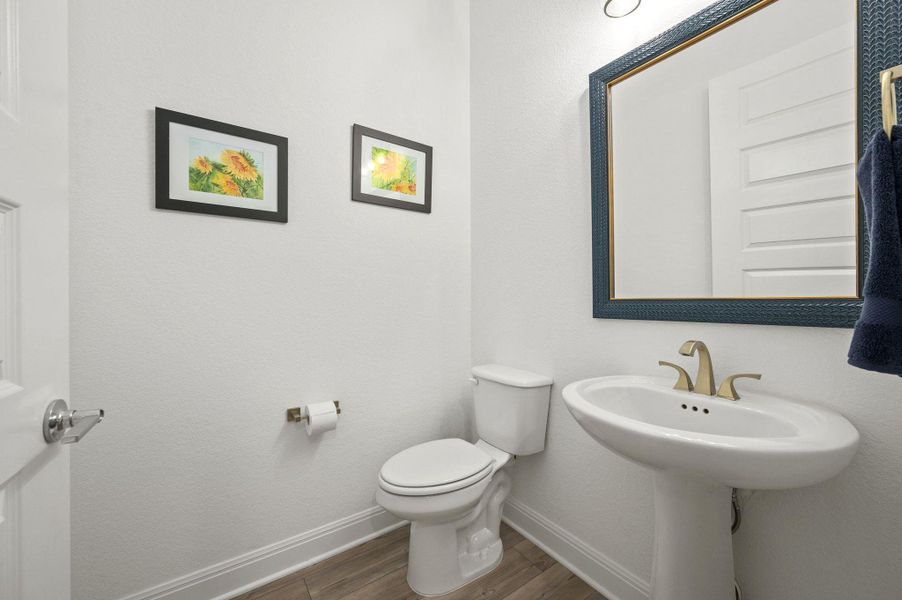 A thoughtfully placed half bath provides comfort and convenience for gatherings A thoughtfully placed half bath provides comfort and convenience for gatherings