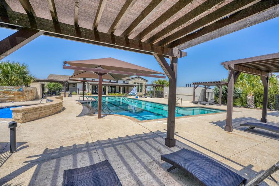 Community pool with a pergola and a patio