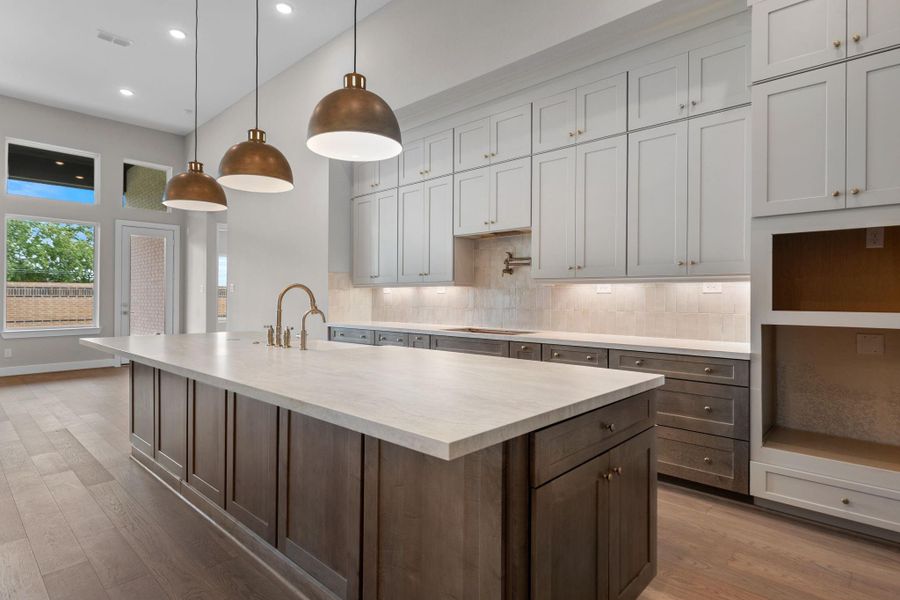 A massive island anchors the generous kitchen, ready for multiple cooks