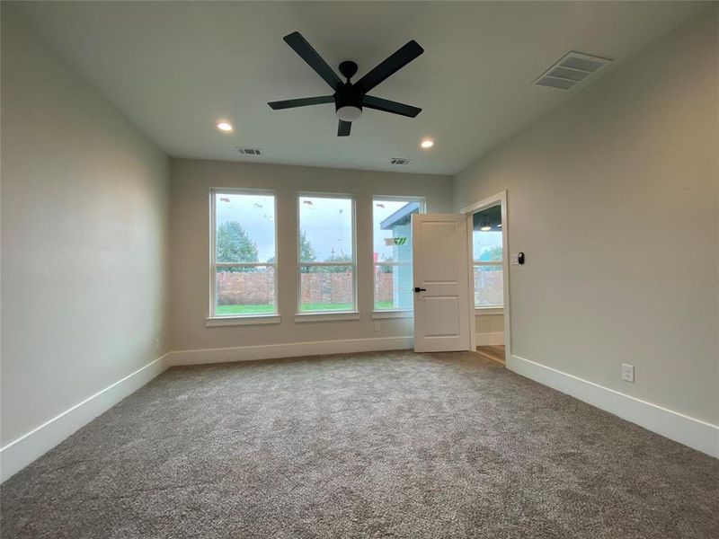 Spare room featuring ceiling fan and carpet flooring