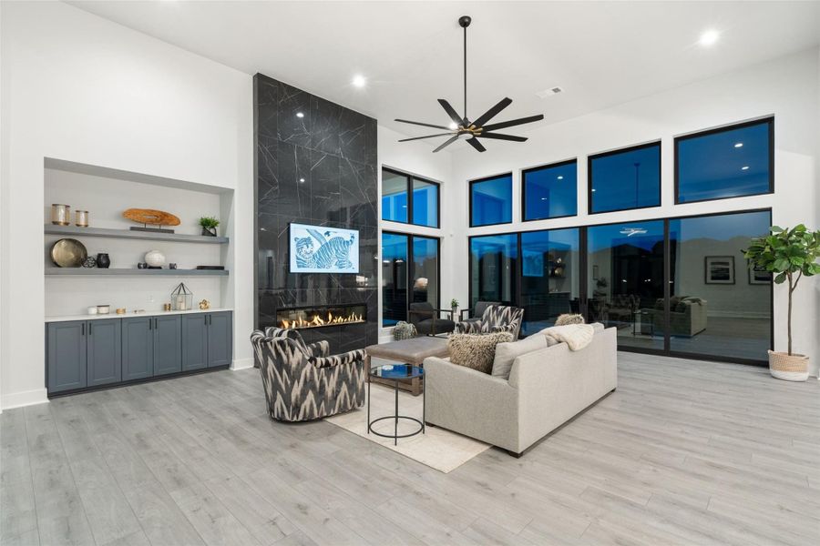 A dramatic floor-to-ceiling stone fireplace anchors the living room while panoramic canyon views provide a spectacular natural backdrop.