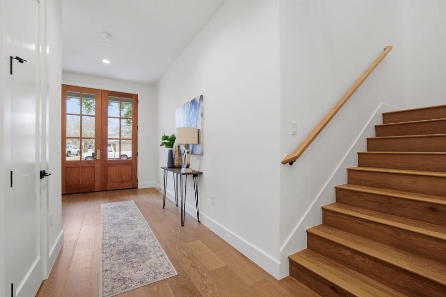 Doorway with french doors, wood finished floors, and recessed lighting
