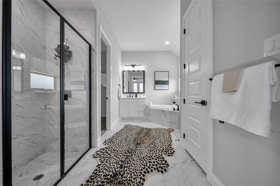 Full bath featuring a marble finish shower, a bath, vanity, light marble finish flooring, and recessed lighting Full bath featuring a marble finish shower, a bath, vanity, light marble finish flooring, and recessed lighting