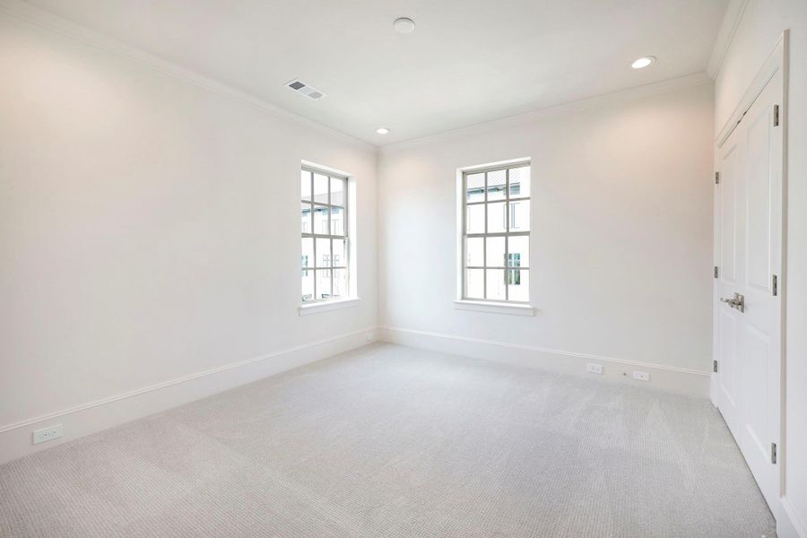 *Previous Model Home* Representative of a secondary bedroom featuring walk-in closet and ensuite bath.