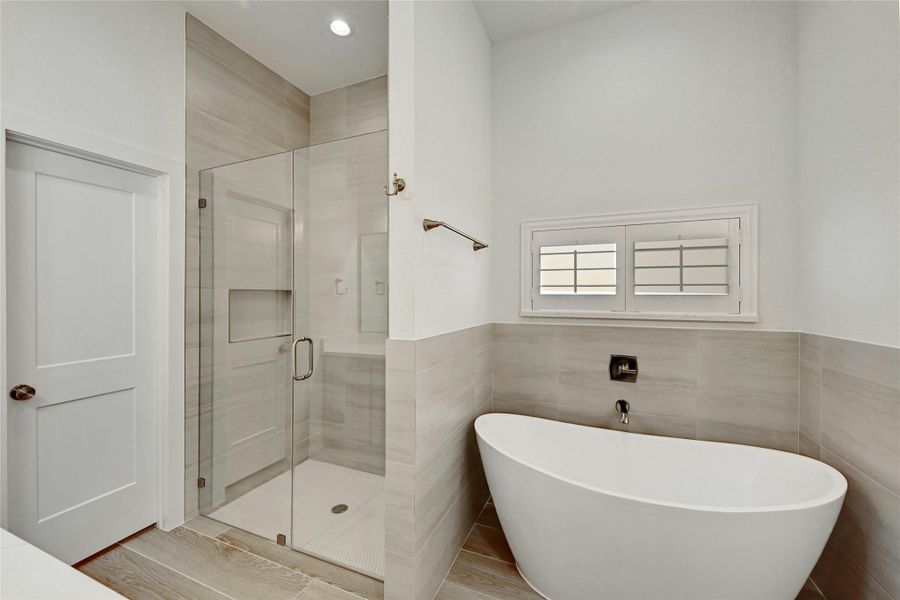 A spacious walk in shower with alongside a garden tub to relax and unwind.