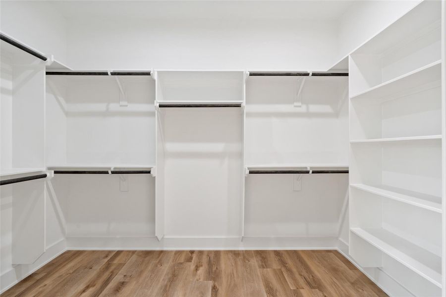 The primary suite includes an oversized walk-in closet, providing ample space for clothing, shoes, and accessories. Its generous layout makes organization effortless while maintaining a sense of luxury. This thoughtfully designed space adds both functionality and elegance to the suite.