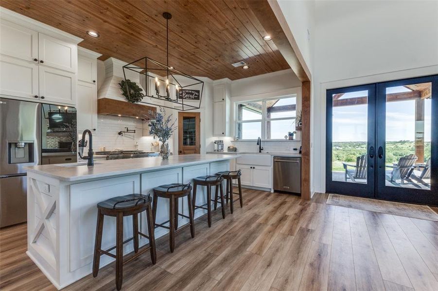Kitchen with stainless steel appliances, a wealth of natural light, and tasteful backsplash Kitchen with stainless steel appliances, a wealth of natural light, and tasteful backsplash