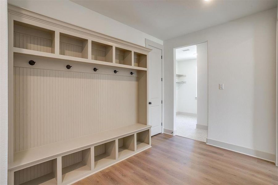 Mudroom featuring baseboards and wood finished floors