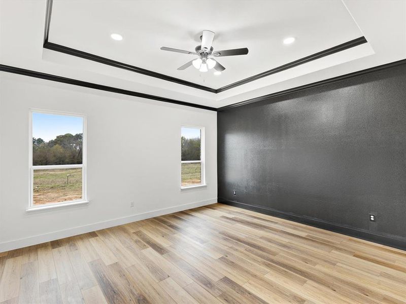 Spare room with light wood-style floors, crown molding, a ceiling fan, and recessed lighting Spare room with light wood-style floors, crown molding, a ceiling fan, and recessed lighting
