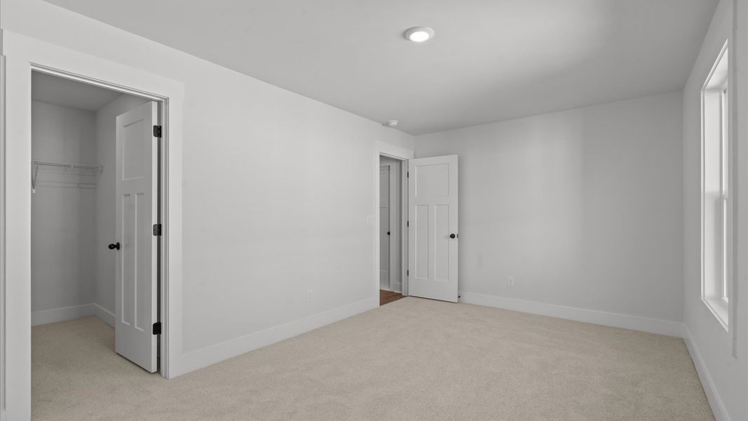 First-class bedroom with generous proportions, a walk-in closet, and beautiful natural light through large windows First-class bedroom with generous proportions, a walk-in closet, and beautiful natural light through large windows