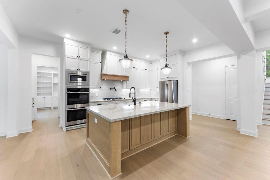 Stunning kitchen with tons of storage, huge island, and beautiful quartz countertops.