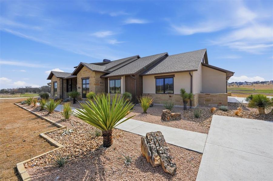 View of front of house featuring stone siding and stucco siding View of front of house featuring stone siding and stucco siding