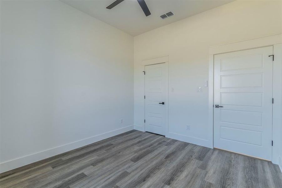 Unfurnished room with wood-type flooring and ceiling fan