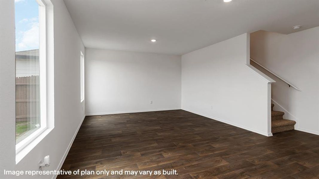 Unfurnished living room featuring stairway, dark wood-type flooring, and recessed lighting