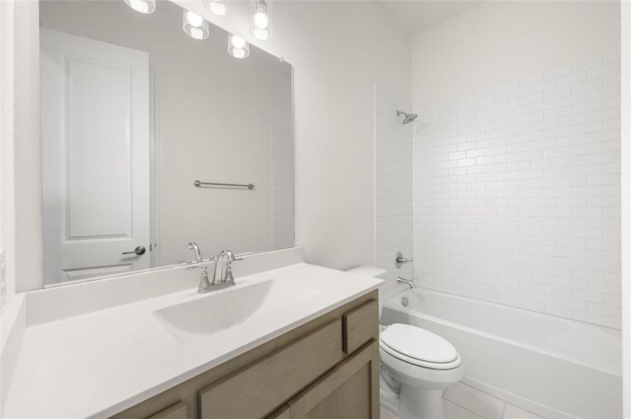 Full bathroom with vanity, shower / tub combination, and tile patterned flooring