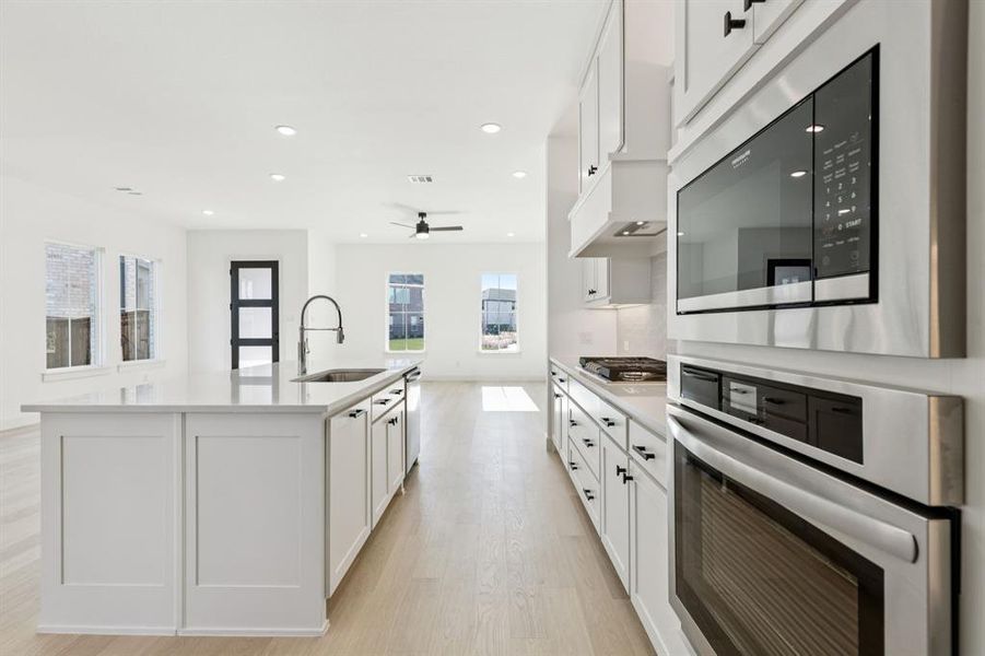 Beautiful cabinetry, gorgeous countertops and light colored flooring effortlessly blend with contemporary stainless steel to create a dream kitchen for the ages!