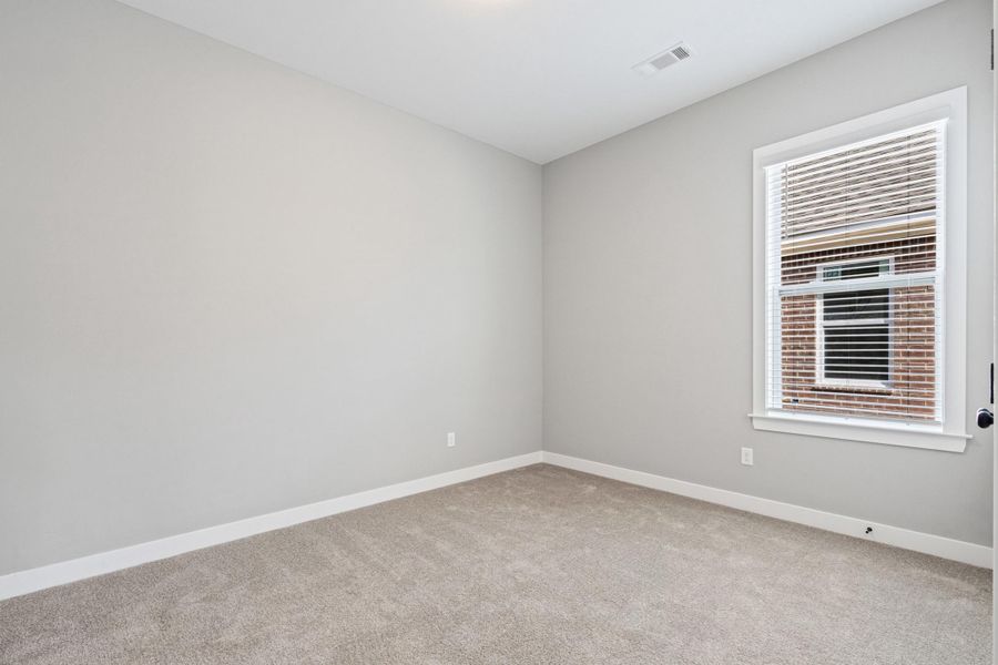 Spare room with baseboards and light carpet