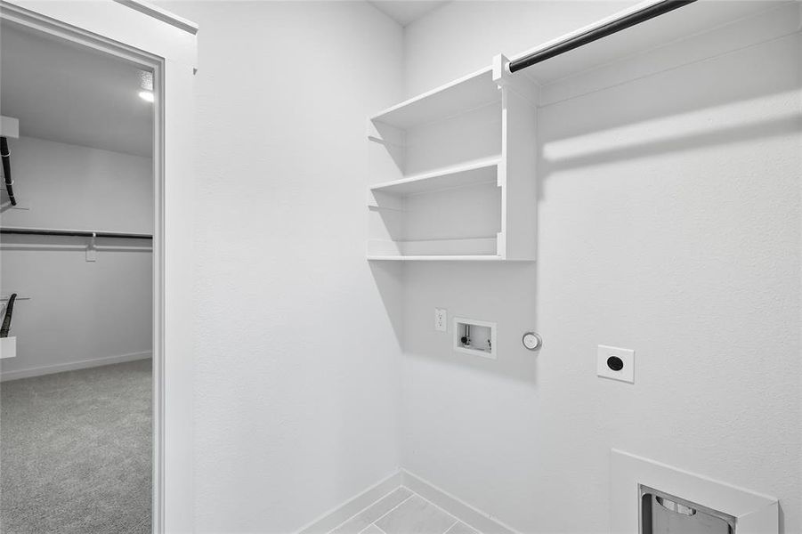 Laundry area with hookup for an electric dryer, hookup for a washing machine, gas dryer hookup, and light colored carpet Laundry area with hookup for an electric dryer, hookup for a washing machine, gas dryer hookup, and light colored carpet