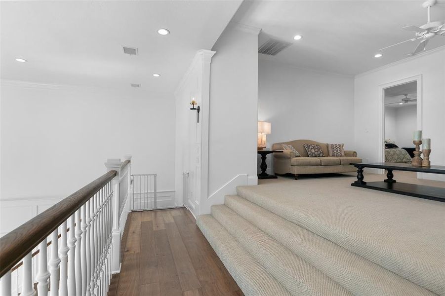 A view from the landing to the stairs up to two of the secondary bedrooms.