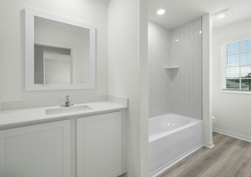 Full bathroom with tile detail in the tub