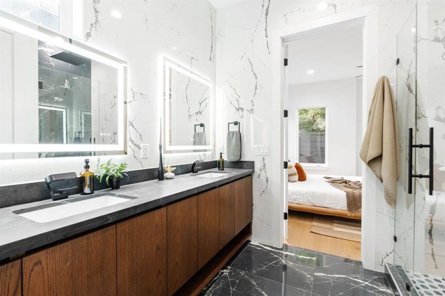 Luxurious primary bathroom with dual vanities