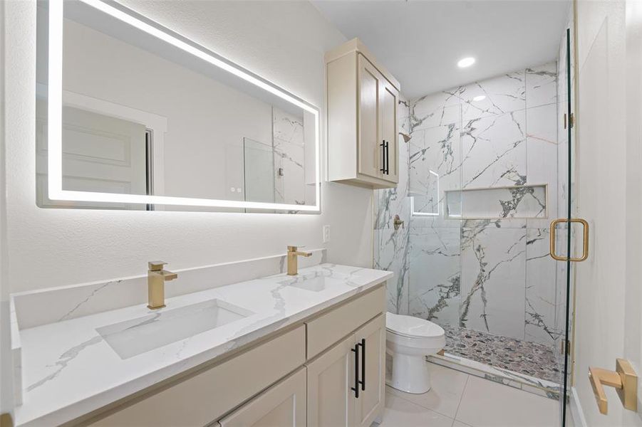 Contemporary bathroom featuring a double vanity with integrated rectangular sinks, a quartz-finish countertop, and gold-tone fixtures Contemporary bathroom featuring a double vanity with integrated rectangular sinks, a quartz-finish countertop, and gold-tone fixtures