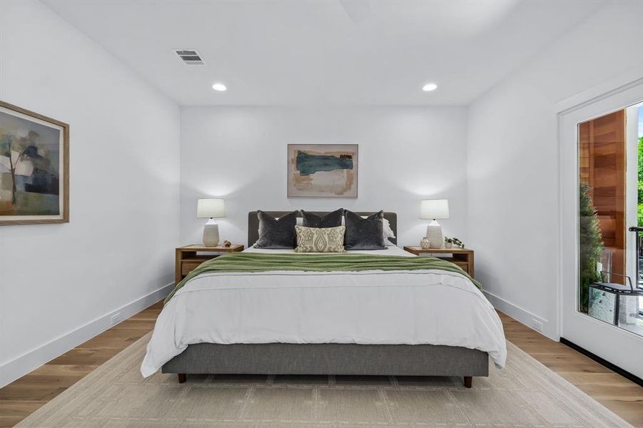 Bedroom with multiple windows and light wood-type flooring