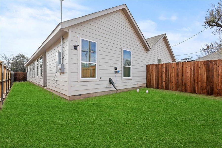 Rear view of property featuring a yard