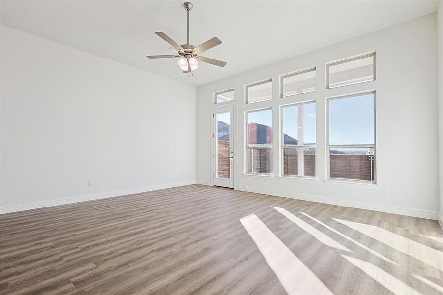 Empty room featuring ceiling fan and light wood-type flooring