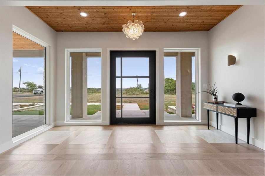 Doorway with wood ceiling, a chandelier, wood
finished floors, and recessed lighting Doorway with wood ceiling, a chandelier, wood
finished floors, and recessed lighting
