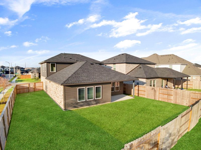 Another aerial perspective displays the backyard’s full scale, fenced perimeter, and extended green area. The home’s layout and exterior design blend style and comfort while maximizing outdoor enjoyment. Another aerial perspective displays the backyard’s full scale, fenced perimeter, and extended green area. The home’s layout and exterior design blend style and comfort while maximizing outdoor enjoyment.