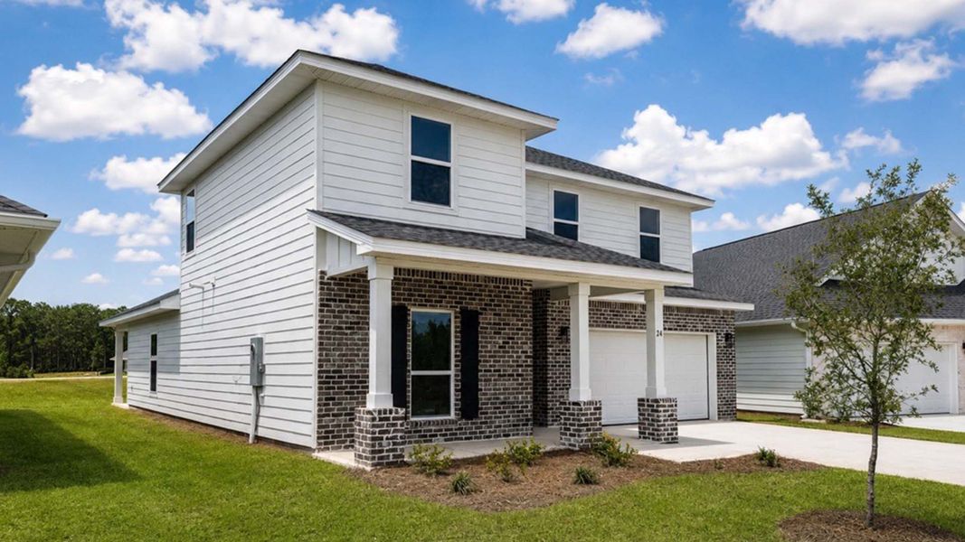 Front exterior of a new home in Ashton Park Phase III, Freeport, FL, highlighting curb appeal (Image 21).