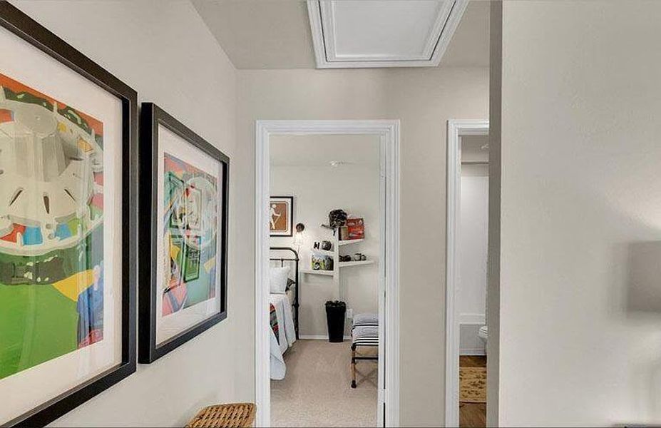 Hallway with carpet and attic access Hallway with carpet and attic access