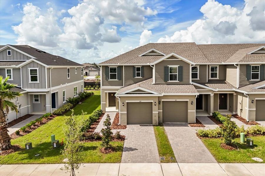 Front exterior of a new home in Reserve at Forest Lake Townhomes, Lake Wales, FL, highlighting curb appeal (Image 1). Front exterior of a new home in Reserve at Forest Lake Townhomes, Lake Wales, FL, highlighting curb appeal (Image 1).