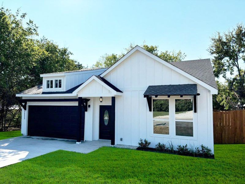 Modern farmhouse with a garage and a front yard