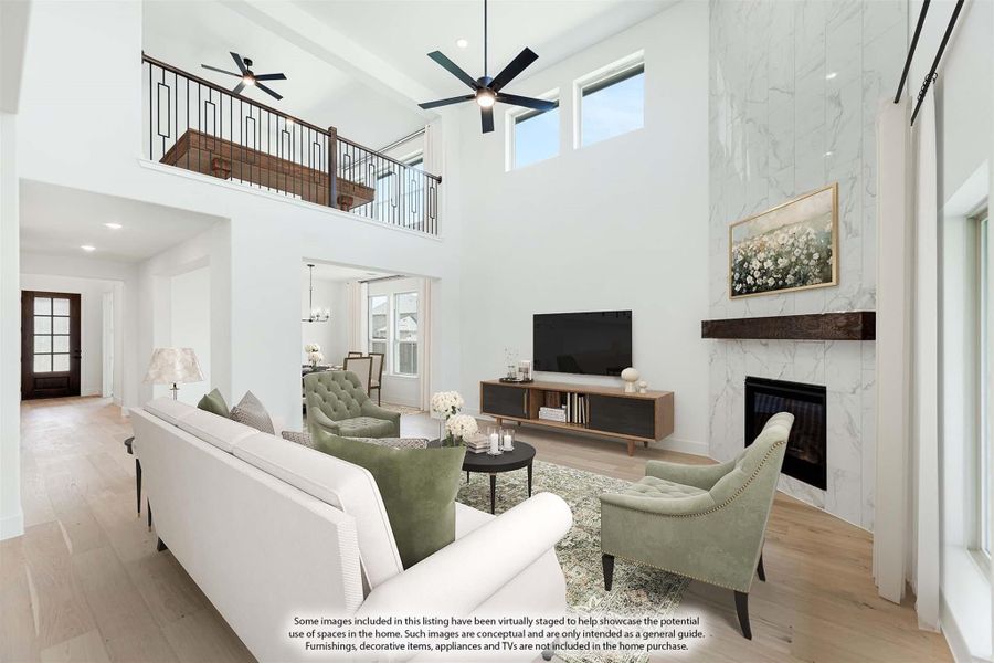 Living room with two-story ceiling, marble fireplace, and open second-floor balcony overlook Living room with two-story ceiling, marble fireplace, and open second-floor balcony overlook